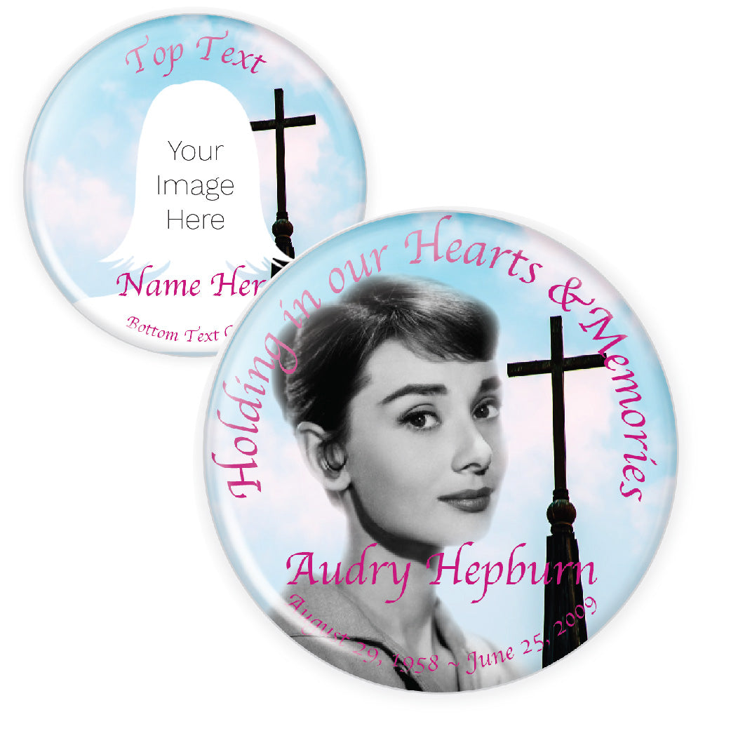 Memorial button featuring a blue sky and soft pink hues with a cross, symbolizing peace and devotion.